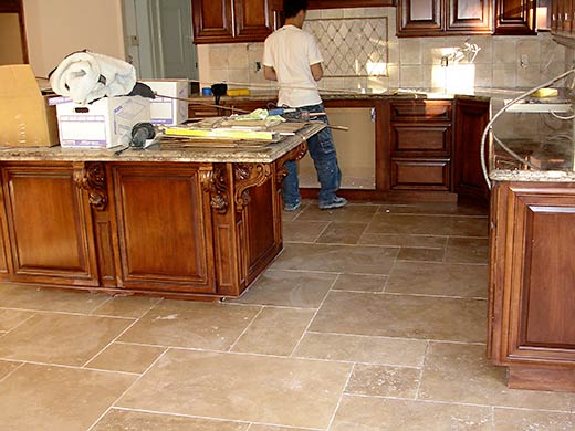 one of our master flooring installers working in a residential kitchen.